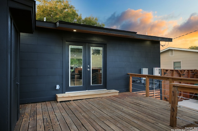 deck at dusk featuring french doors