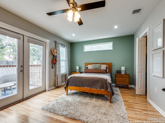 bedroom with light hardwood / wood-style flooring, french doors, access to exterior, and ceiling fan