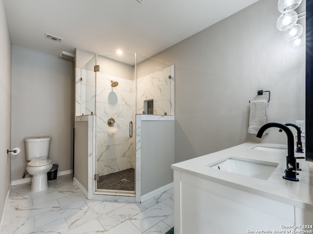 bathroom featuring toilet, a shower with shower door, and vanity