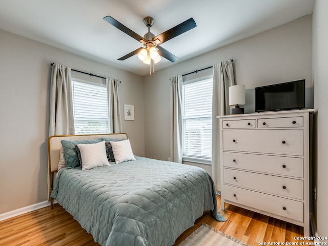 bedroom featuring light hardwood / wood-style floors and ceiling fan