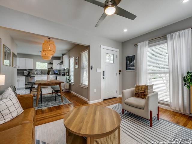 living room featuring light hardwood / wood-style floors and ceiling fan