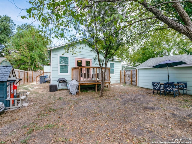 back of house with a wooden deck