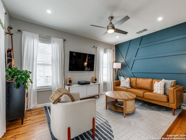 living room with light hardwood / wood-style floors and ceiling fan