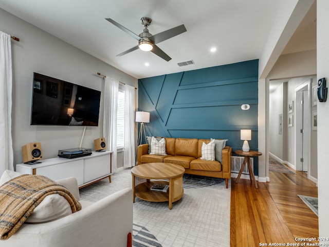 living room featuring light wood-type flooring and ceiling fan