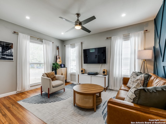 living room with light wood-type flooring and ceiling fan