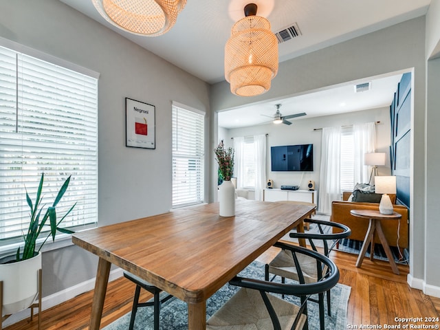 dining space with ceiling fan, wood-type flooring, and plenty of natural light