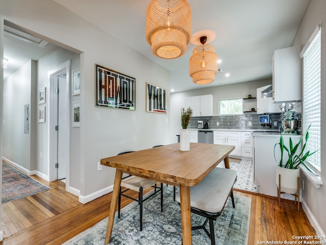 dining space with light hardwood / wood-style flooring and sink