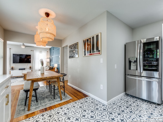 dining area featuring an inviting chandelier and light hardwood / wood-style flooring