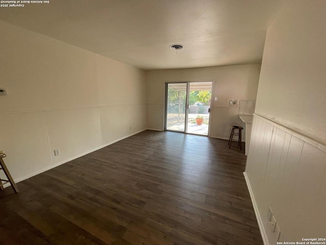 unfurnished living room featuring dark wood-type flooring