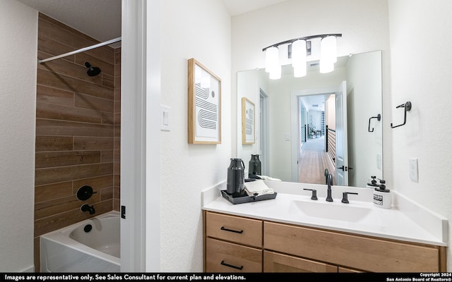 bathroom featuring vanity and tiled shower / bath combo