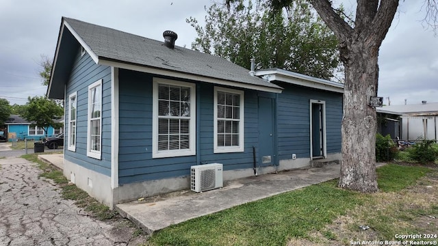 back of house with ac unit