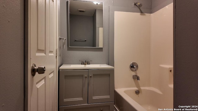 bathroom featuring  shower combination and vanity