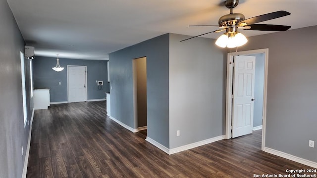 unfurnished room featuring dark wood-type flooring and ceiling fan