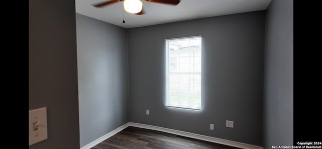 empty room with ceiling fan and dark hardwood / wood-style floors