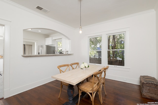 dining area with crown molding and dark hardwood / wood-style floors