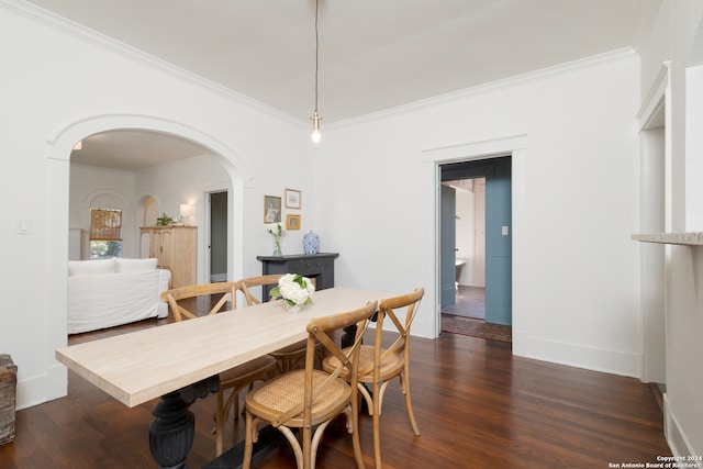 dining room with dark wood-type flooring and ornamental molding