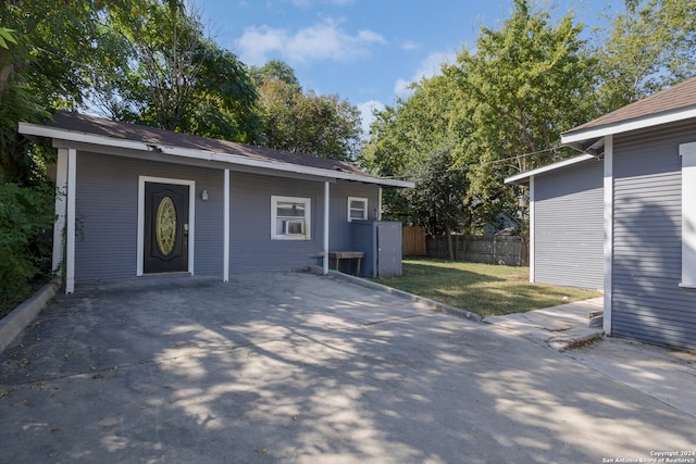 back of property featuring a patio and a lawn