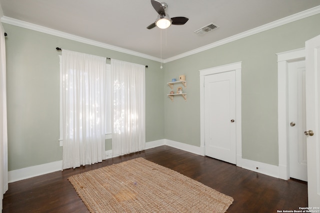 unfurnished bedroom with ornamental molding, dark hardwood / wood-style floors, and ceiling fan