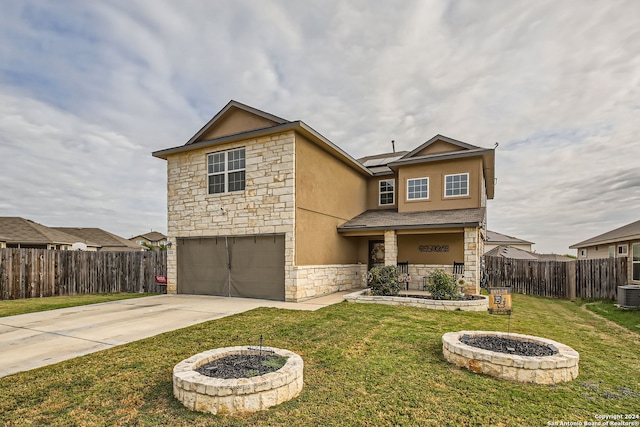 view of front facade with a front lawn, a garage, an outdoor fire pit, and cooling unit