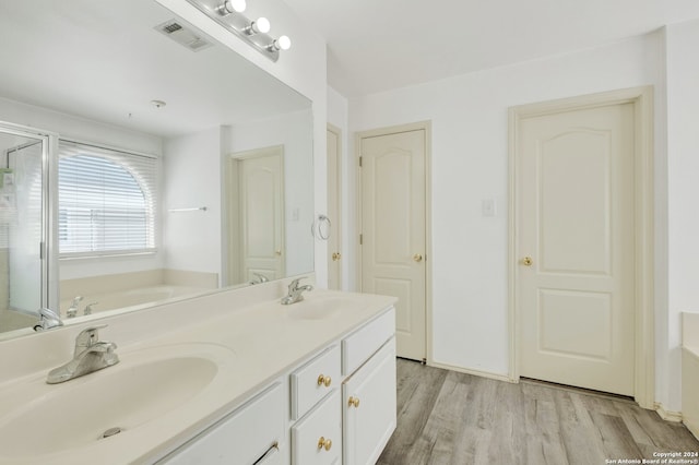 bathroom featuring a bathtub, wood-type flooring, and vanity