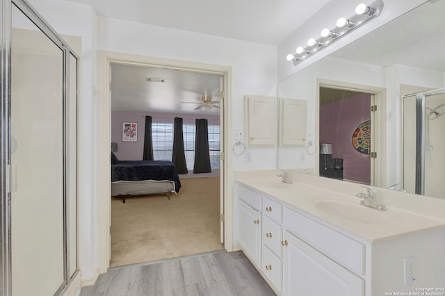 bathroom featuring vanity, an enclosed shower, wood-type flooring, and ceiling fan