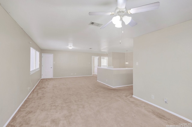 empty room featuring light colored carpet and ceiling fan