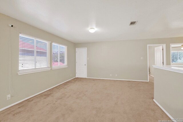 carpeted empty room with ceiling fan