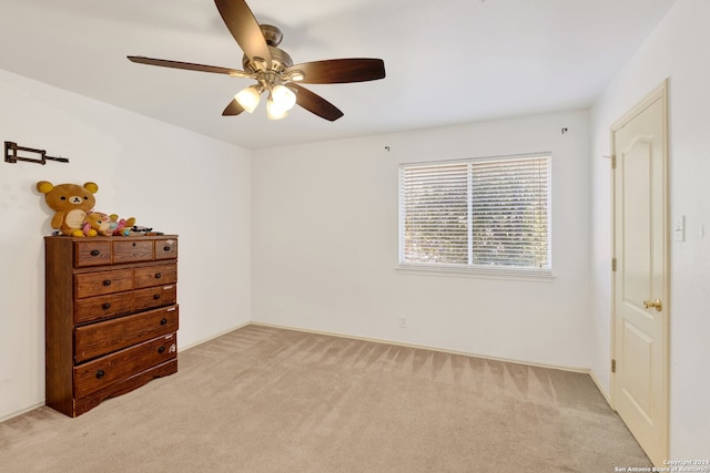 unfurnished bedroom with ceiling fan and light carpet