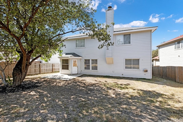 back of property with a patio