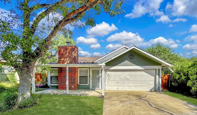 ranch-style house featuring a front yard and a garage