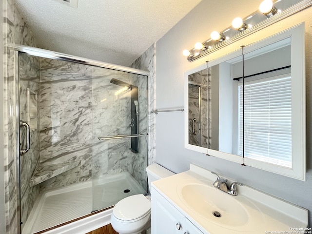 bathroom featuring vanity, a textured ceiling, toilet, and an enclosed shower