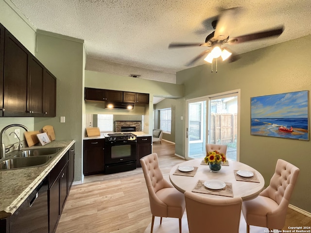 dining room featuring light hardwood / wood-style flooring, a textured ceiling, sink, and ceiling fan