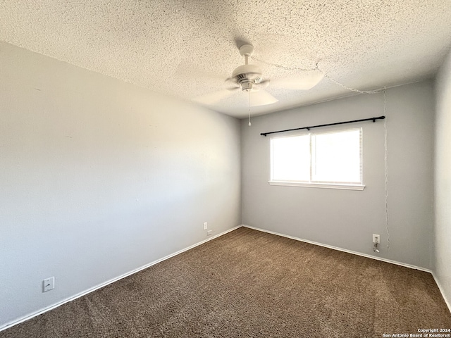 carpeted spare room featuring ceiling fan and a textured ceiling