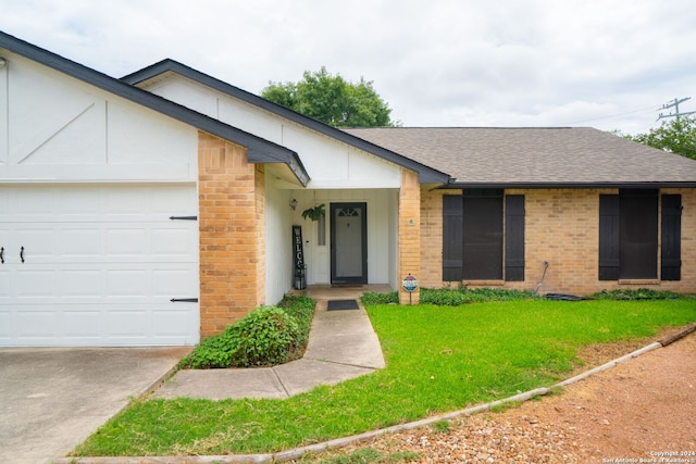 ranch-style house featuring a garage and a front lawn