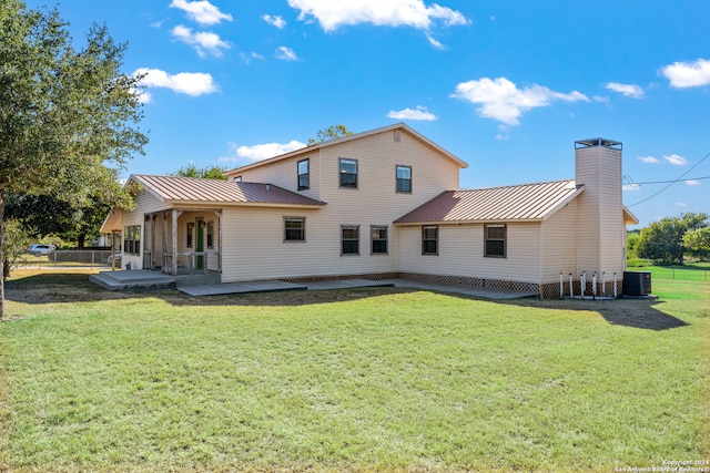 rear view of property with a patio area, a lawn, and central AC unit