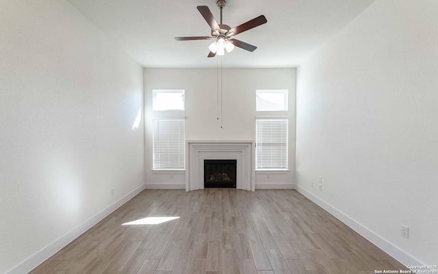 1806 Small Ship, San Antonio, TX 78245 - unfurnished living room featuring ceiling fan, light wood finished floors, and a fireplace