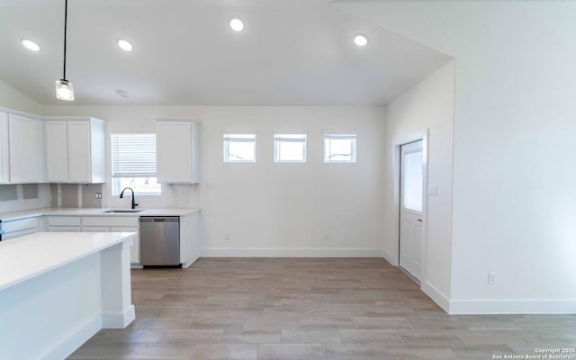 1806 Small Ship, San Antonio, TX 78245 - kitchen featuring stainless steel dishwasher, healthy amount of natural light, white cabinetry, light countertops, and recessed lighting