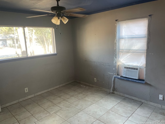 empty room featuring cooling unit and ceiling fan