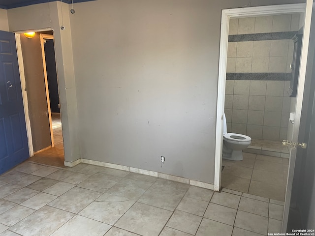 bathroom with toilet and tile patterned flooring