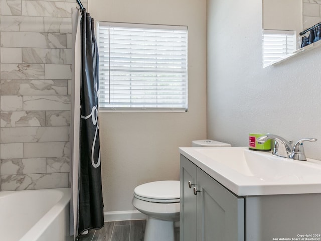 full bathroom with shower / tub combo with curtain, vanity, hardwood / wood-style flooring, and toilet