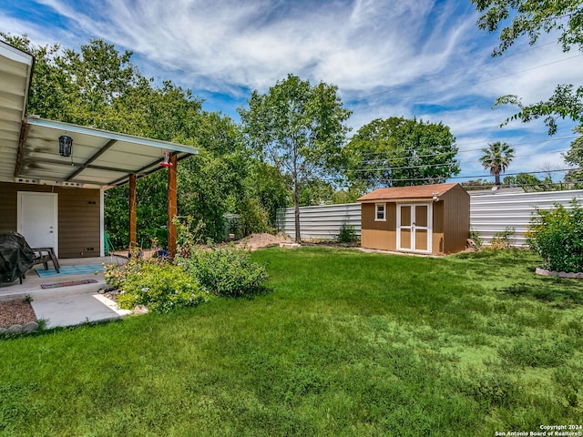 view of yard with a storage unit and a carport