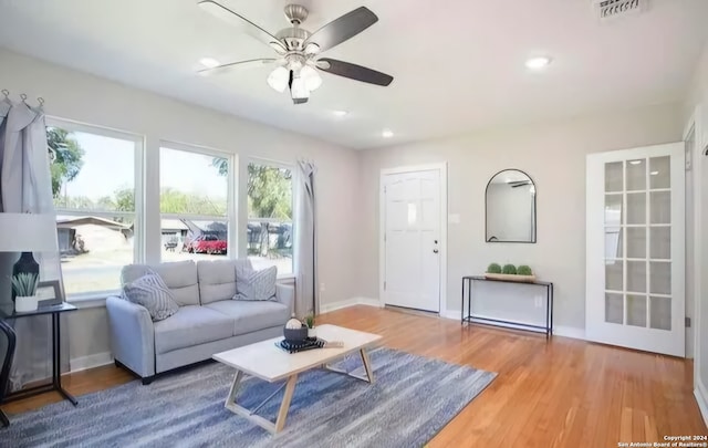 living room featuring hardwood / wood-style floors and ceiling fan