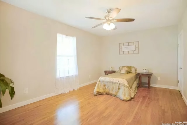 bedroom with light hardwood / wood-style floors and ceiling fan