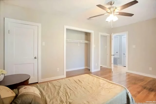 bedroom featuring a closet, light hardwood / wood-style floors, and ceiling fan