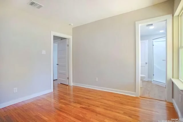 spare room with wood-type flooring