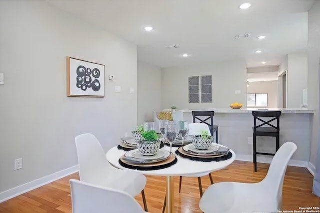 dining space with light hardwood / wood-style flooring