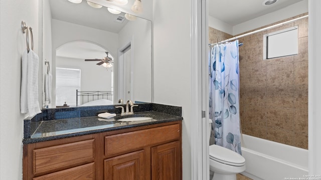 full bathroom with vanity, shower / tub combo with curtain, toilet, and ceiling fan