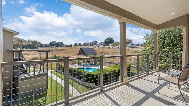 balcony featuring a patio and a rural view