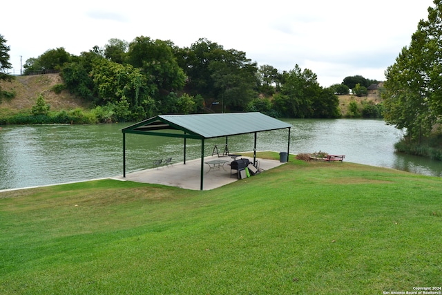 view of dock featuring a gazebo, a water view, and a lawn