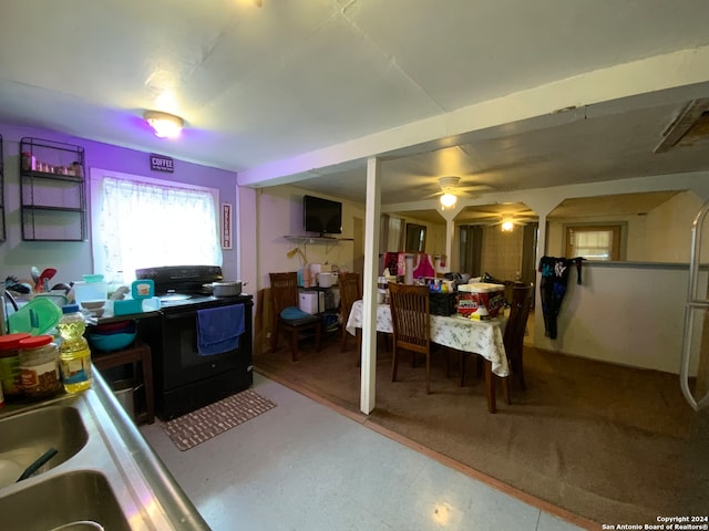 kitchen featuring sink, ceiling fan, and black range with electric stovetop